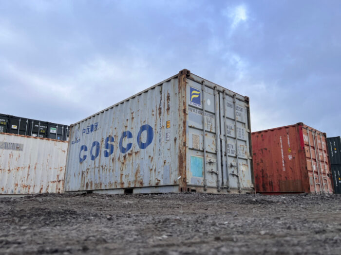 Ground-level angle of COSCO 20ft container showing full exterior detail and door