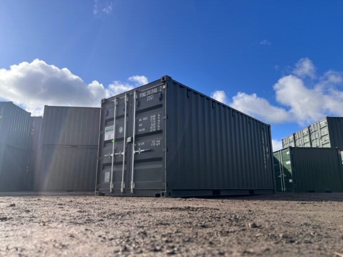 Front view of green 20ft shipping container with secure locking doors and weight markings.